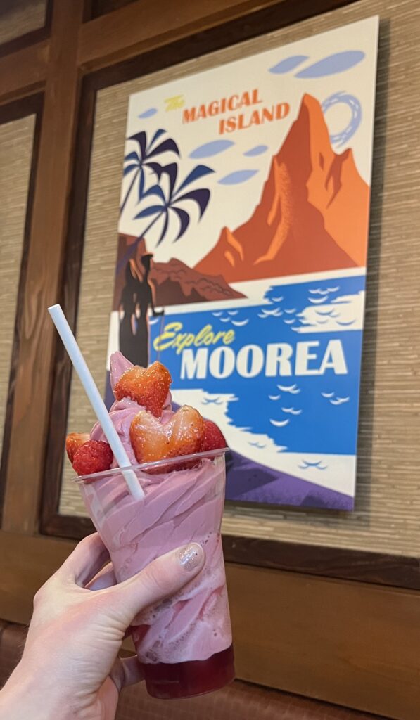 Pink soft serve with strawberry slices shaped like hearts.