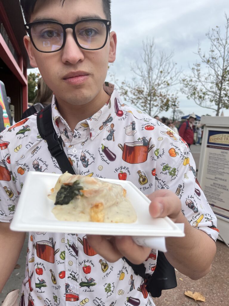 Alix holds out a salmon and spinach puff pastry.