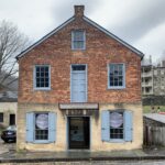 A brick colonial building with the sign "Merriwether Lewis"