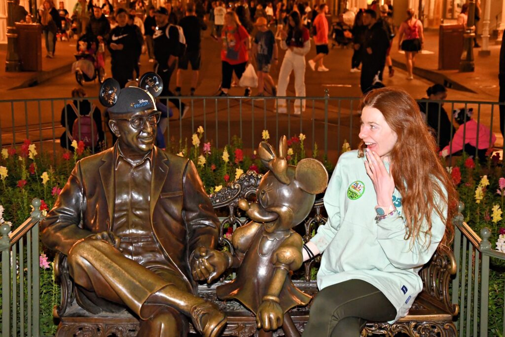 Bri acts like she is shocked to be speaking to Walt Disney who she placed her graduation ears on his statue.