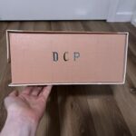 Side of the box with sticker letters spelling out "DCP"