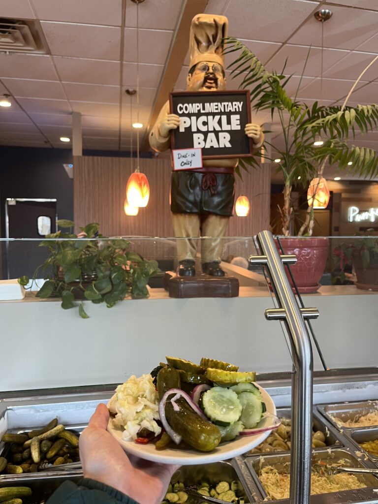 A small-plate filled with pickles and pickled veggies.