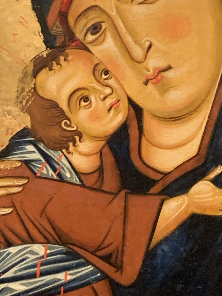 A close up picture of a renaissance painting featuring a baby.