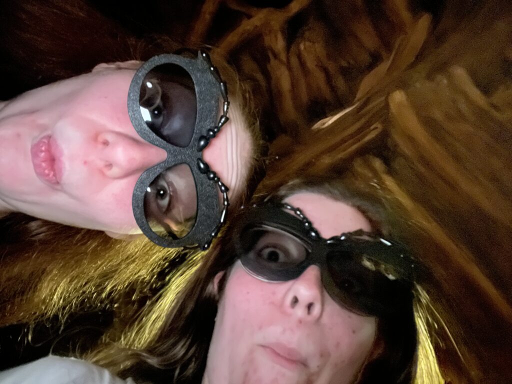 Silly selfie of Sarah and Bri in bug eyes shaped 3D glasses.